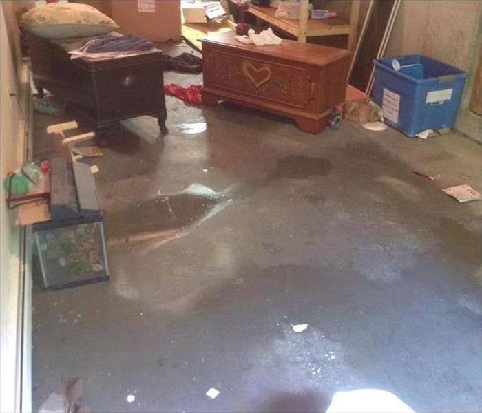 water on concrete floor, scattered contents