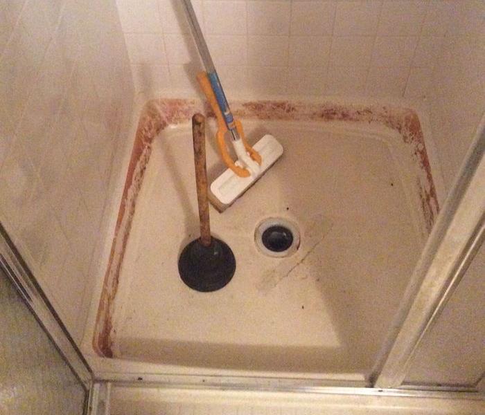  Shower pan with brown stains on the tile