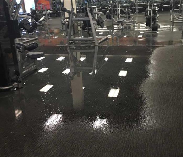 fitness center floor and equipment with water pooling