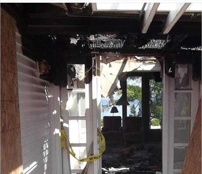 white front entrance with black burned ceiling and interior room fire damage