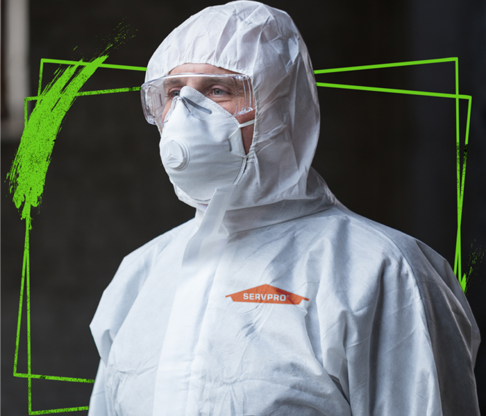 SERVPRO tech wearing protective body suit, mask, and goggles.